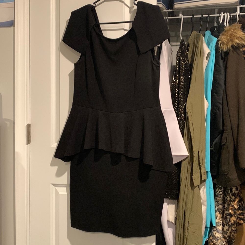 Black plus size peplum dress with petal sleeves.